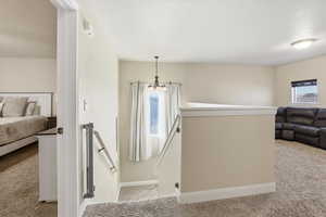 Staircase with carpet flooring and baseboards