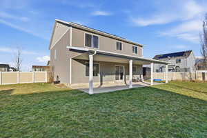 Rear view of property featuring a patio area and a fenced backyard