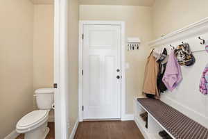 Mudroom with dark wood-style floors and baseboards