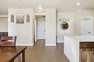 Kitchen featuring light wood-type flooring, light stone counters, and recessed lighting
