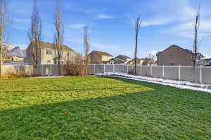 Fenced backyard featuring a residential view