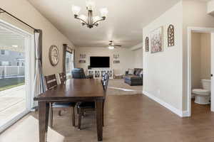 Dining space featuring a chandelier, ceiling fan, and light wood-style flooring