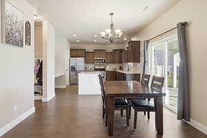 Dining space featuring a chandelier, dark wood-style floors, and recessed lighting