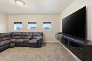 Living room with light colored carpet and baseboards