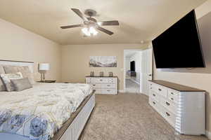 Bedroom featuring ceiling fan and light carpet