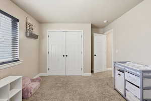 Recreation room featuring light colored carpet and baseboards