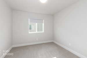 Unfurnished room with carpet floors and baseboards