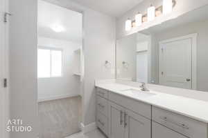 Bathroom with light carpet and vanity
