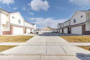 View of concrete driveway with a residential view