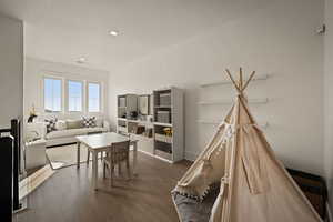 Living room with wood finished floors and recessed lighting