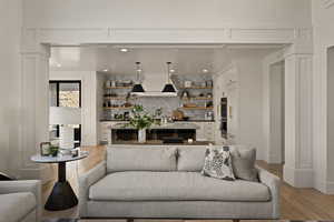 Living area with light wood-type flooring and recessed lighting