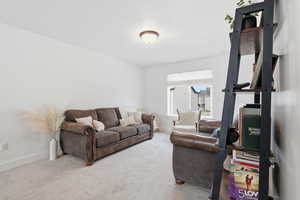 Living room with carpet flooring and baseboards