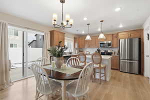Dining area featuring light wood-style flooring, a chandelier, and recessed lighting