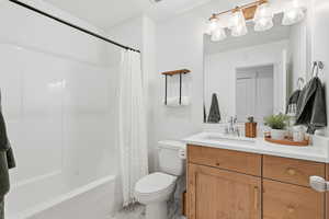 Bathroom featuring vanity and shower / tub combo with curtain