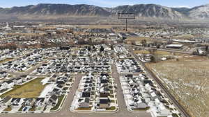Aerial view of property's location with nearby suburban area and a mountain backdrop