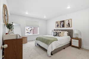 Carpeted bedroom with baseboards and recessed lighting