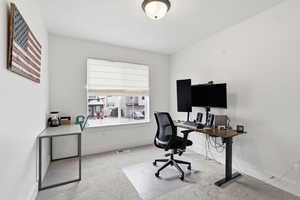 Office with light carpet and baseboards