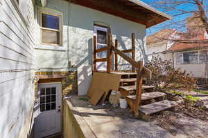 Entrance to property featuring brick siding