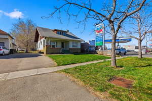 View of front of property featuring a front yard, brick siding, and a porch