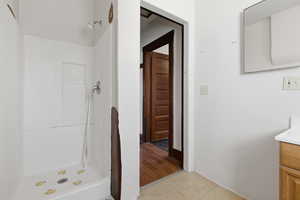Bathroom with vanity and a shower stall