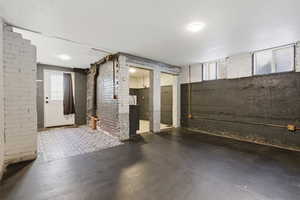 Below grade area with brick wall
