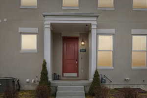 Doorway to property with stucco siding