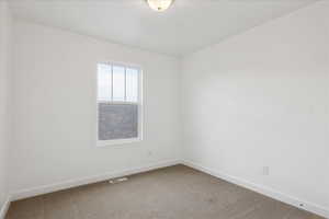 Unfurnished room featuring baseboards and light colored carpet