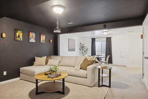 Living room featuring baseboards and light colored carpet