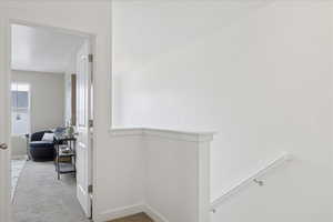 Hall with an upstairs landing and carpet