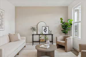 Living area featuring carpet floors and baseboards