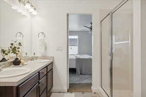 Ensuite bathroom featuring double vanity and a stall shower