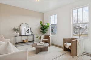 Living area with baseboards and carpet
