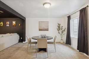 Dining room featuring light colored carpet