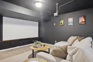 Home theater with carpet floors and baseboards