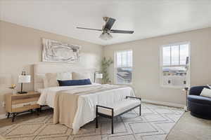 Bedroom with light carpet and ceiling fan