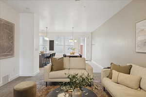 Living area featuring baseboards and a chandelier