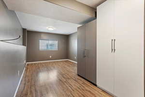 Unfurnished bedroom featuring a textured ceiling and light wood-style flooring