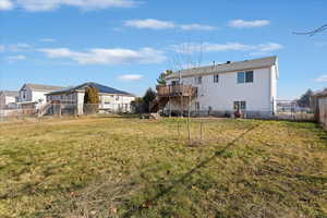 Back of house featuring a fenced backyard, stairway, a deck, and a gate