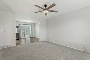 Empty room with carpet floors and ceiling fan