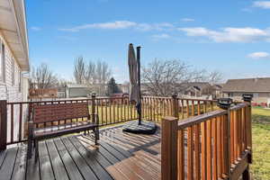 Deck with a residential view and a lawn