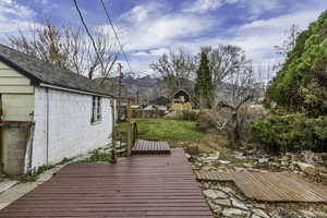 Deck with a mountain view and an outdoor structure