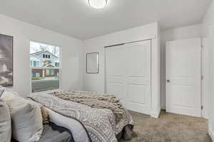 Bedroom featuring carpet flooring and a closet