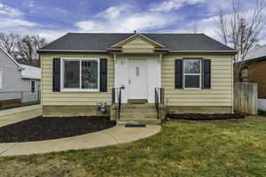 Bungalow-style home with roof with shingles