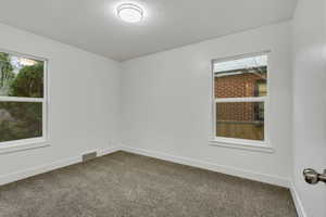Unfurnished room featuring carpet floors and baseboards