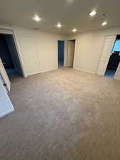Below grade area featuring carpet floors and recessed lighting