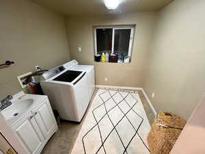 Laundry room featuring independent washer and dryer and baseboards