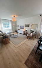 Living area featuring a decorative wall and wood finished floors