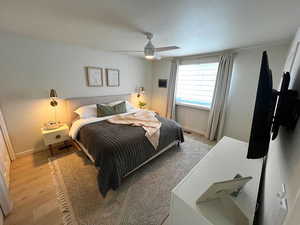 Bedroom with a ceiling fan and wood finished floors
