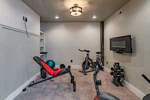 Exercise area featuring carpet floors and recessed lighting