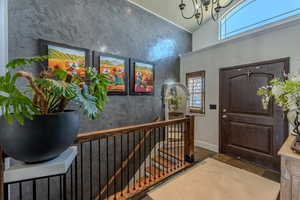 Foyer featuring stairway and a chandelier